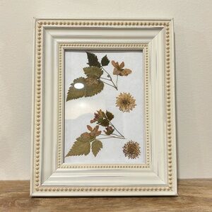 White picture frame with pressed flowers